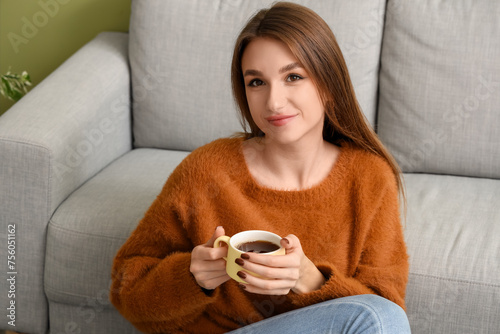 Young woman with cup of tea...