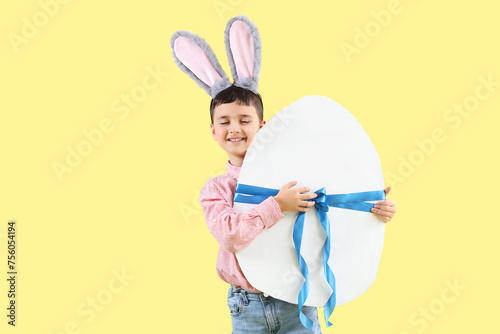 Smiling boy wearing bunny e...