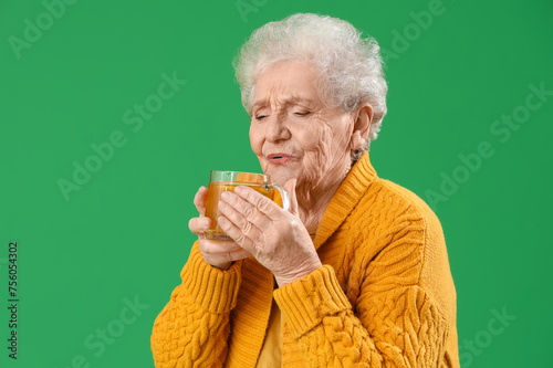 Elderly woman enjoying warm...