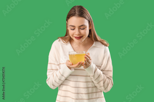 Young woman with glass cup ...
