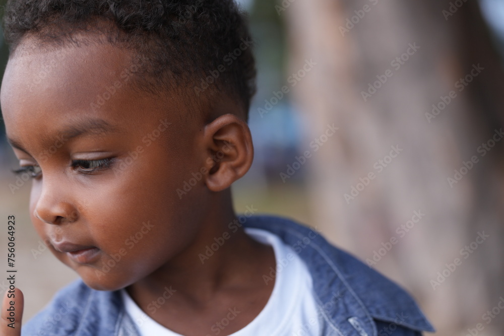 Mixed race African and Asian boy is playing at the outdoor area. smiling happy boy has fun running on the beach. portrait of boy lifestyle with a unique hairstyle. Mixed race African and Asian boy is playing at the outdoor area. smiling happy boy has fun running on the beach. portrait of boy lifestyle with a unique hairstyle.