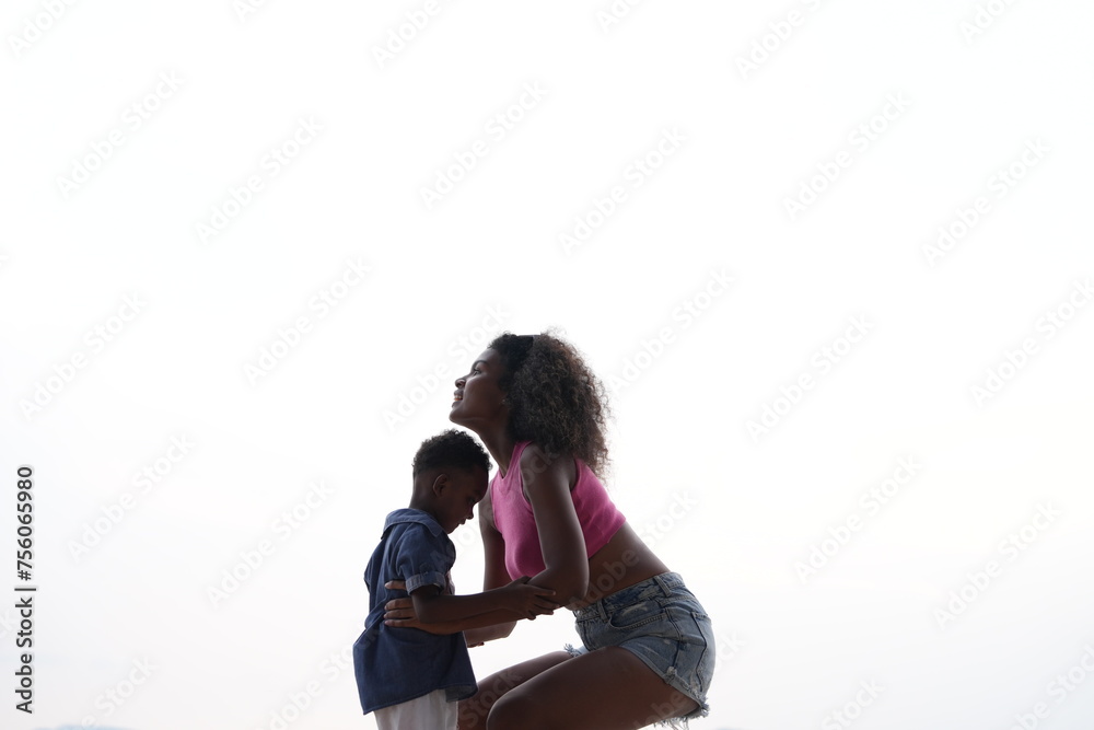 Mixed race African and Asian mother and boy is playing at the outdoor area. smiling happy family have fun running on the beach. portrait of mom and kid lifestyle with a unique hairstyle. Mixed race African and Asian mother and boy is playing at the outdoor area. smiling happy family have fun running on the beach. portrait of mom and kid lifestyle with a unique hairstyle.