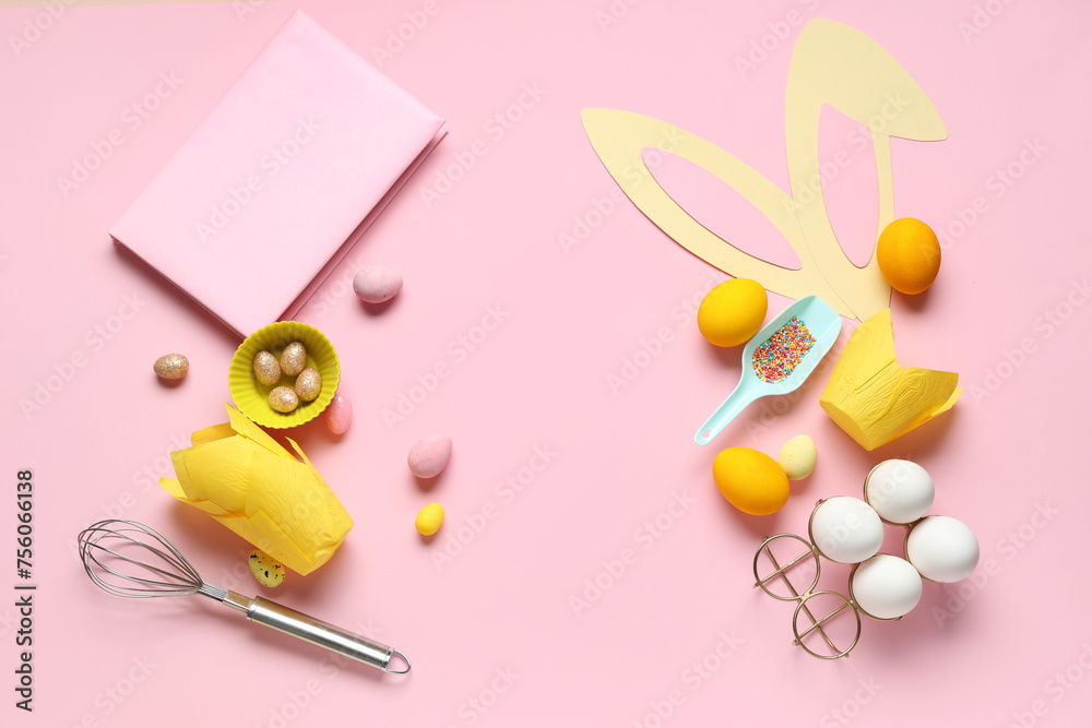 Notepad for recipes with bunny ears, Easter eggs and baking tools on pink background