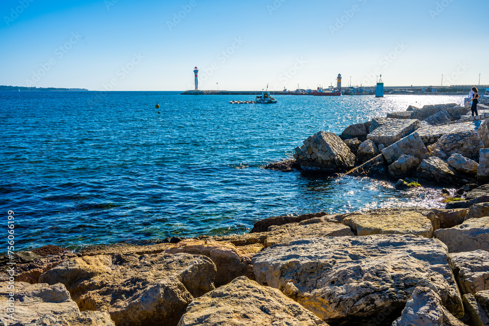 Sunny Day at the Rocky Shoreline of Cannes with Lighthouse View, France