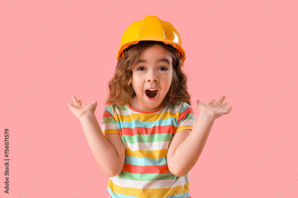 Shocked little girl in hardhat on pink background Shocked little girl in hardhat on pink background