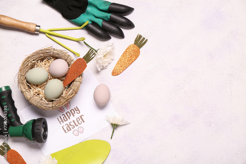 Composition with greeting card, gardening tools and Easter decor on light background Composition with greeting card, gardening tools and Easter decor on light background