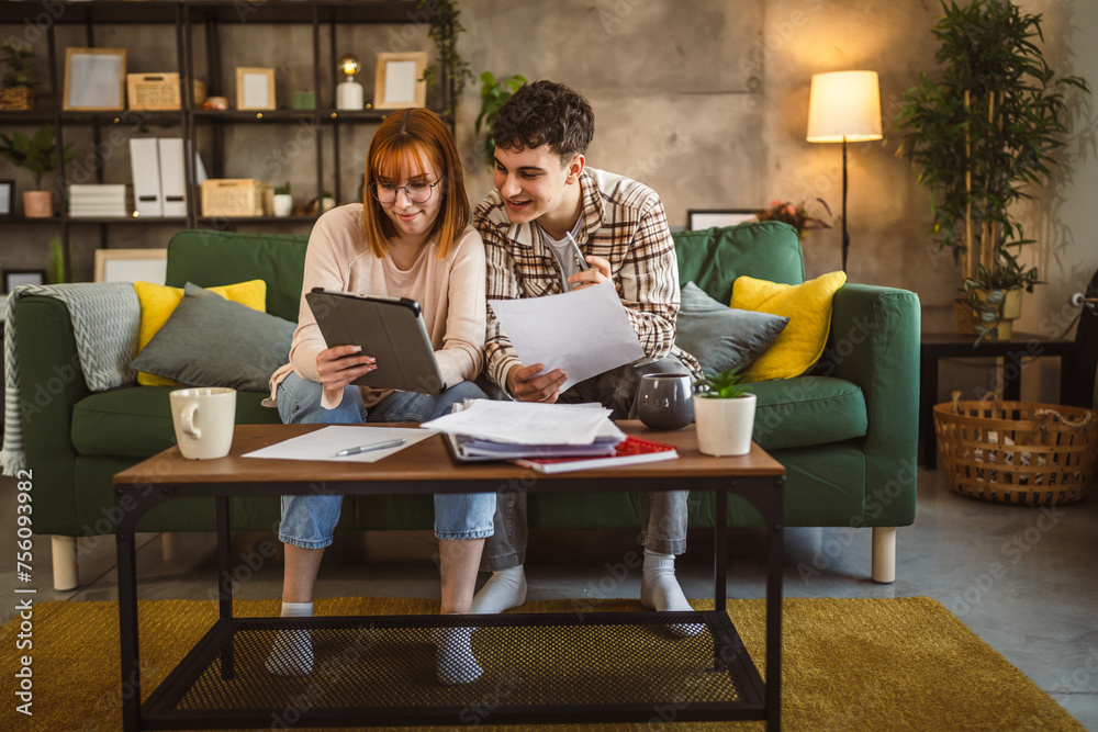 Young couple boyfriend and girlfriend or brother sister study at home Young couple boyfriend and girlfriend or brother sister study at home