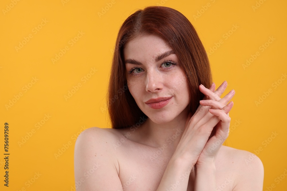 Portrait of beautiful woman with freckles on yellow background Portrait of beautiful woman with freckles on yellow background