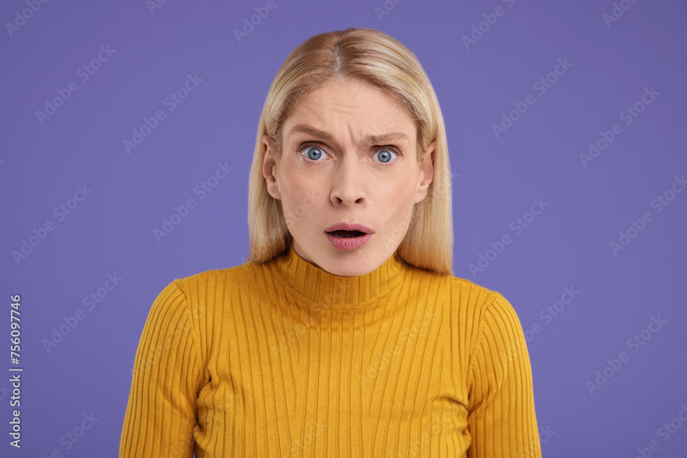 Portrait of surprised woman on violet background Portrait of surprised woman on violet background