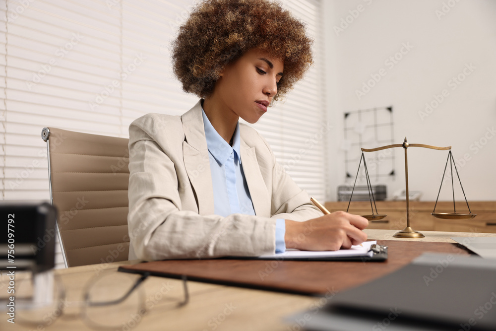 Notary with clipboard writing notes at workplace in office Notary with clipboard writing notes at workplace in office