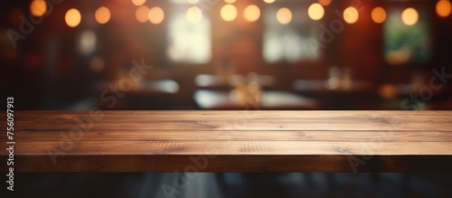Empty wooden table in blurred restaurant background for product display.