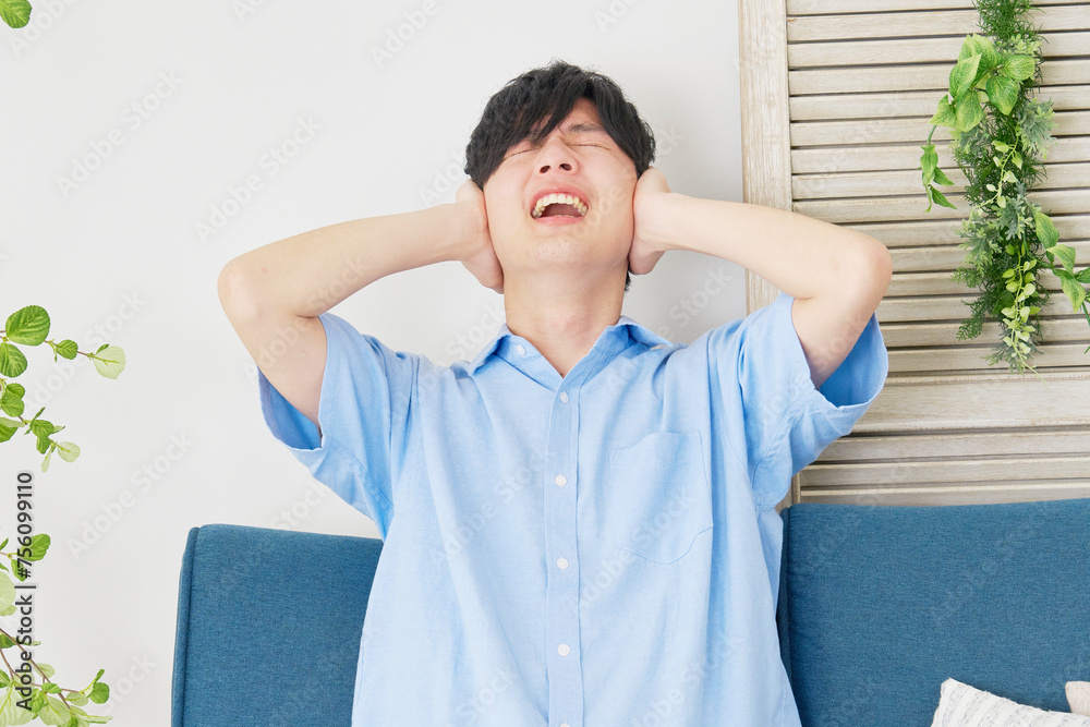 騒音に悩む若い男性 騒音に悩む若い男性
