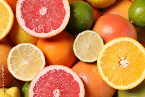 Fototapeta Naklejka Na Ścianę i Meble -  Different fresh citrus fruits as background, top view