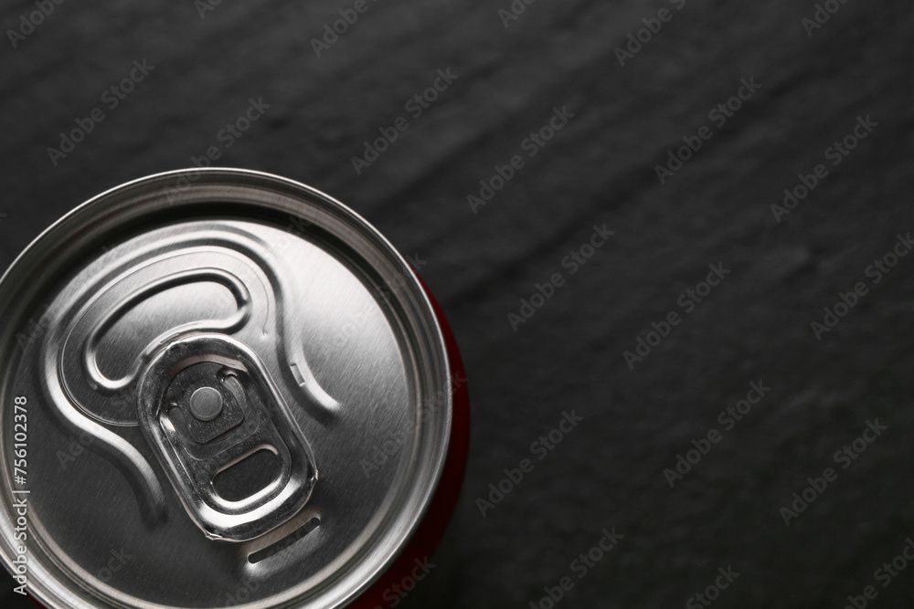 Energy drink in can on black textured background, top view. Space for text Energy drink in can on black textured background, top view. Space for text