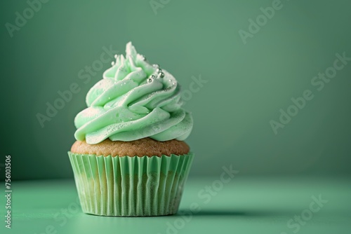 St. Patrick Cupcake with green frosting on pastel green background.