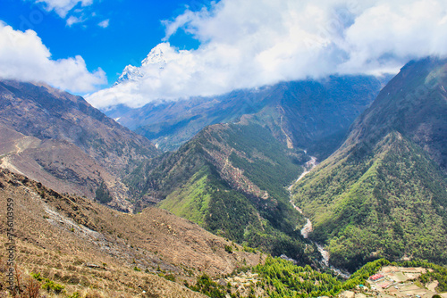 The Village of Phortse Thanga sits in a deep valley with Ama Dablam towering over the landscape on the route towards Dole on the Gokyo trail in upper Khumbu, Nepal photo