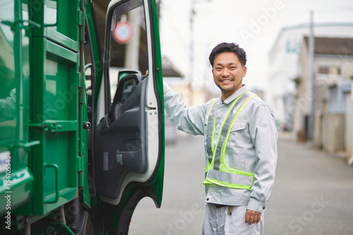 パッカー車と笑っている男性の作業員 photo