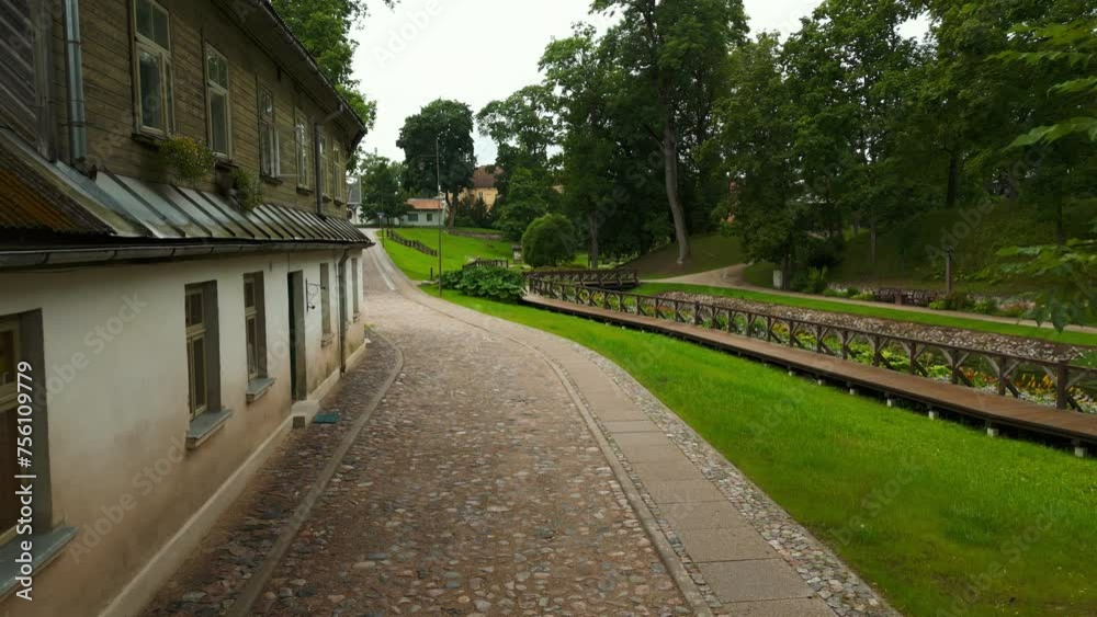 Aerial river crossing building: View from above reveals a structure next to a watercourse with a bridge, creating an idyllic scene in the midst of a natural landscape