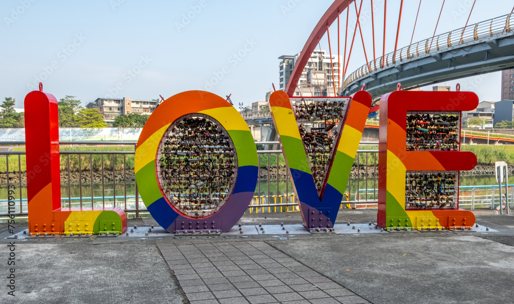 Fototapeta premium Rainbow sign LOVE along a footpath in downtown Taipei