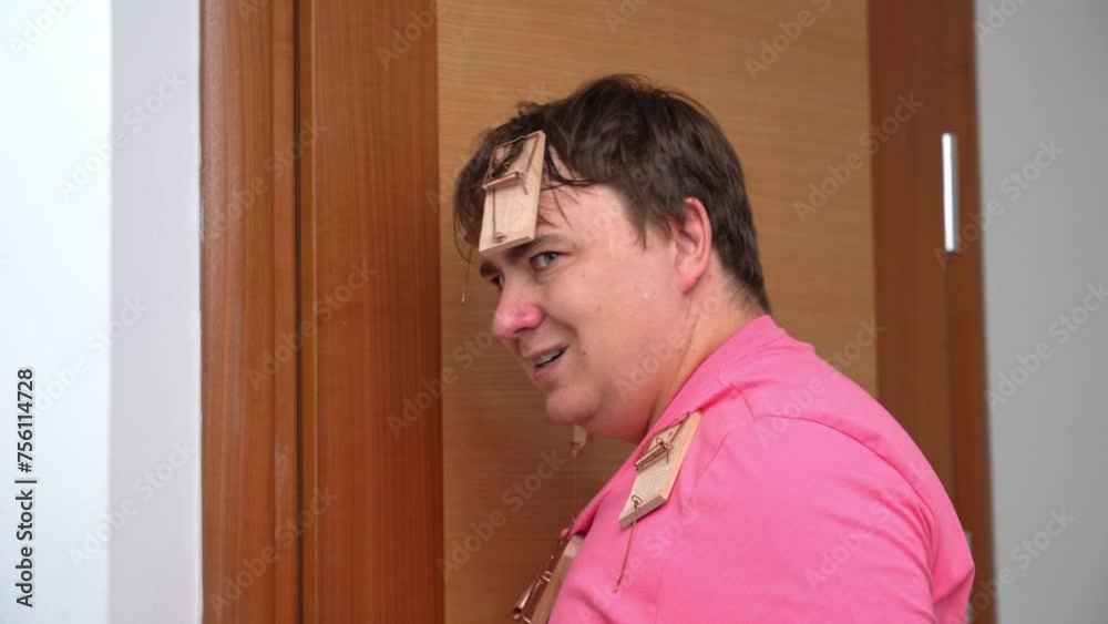 Man closes door, removes mousetrap from nose, looks angrily, comes up with cunning plan for revenge, is obsessed with confrontation, decisively raises finger, idea April Fool Day prank confrontation