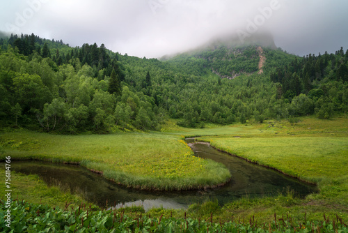 View from the tourist trail to the Dukka Lakes to the valley of the Malaya Dukka River, surrounded by the mountains of the North Caucasus on a sunny summer day, Arkhyz, Karachay-Cherkessia, Russia © Ula Ulachka