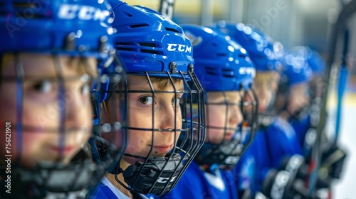 Two teams of kids line up on either side of the rink ready for a competitive game of youth hockey. Some are focused and serious while others cant stop grinning.