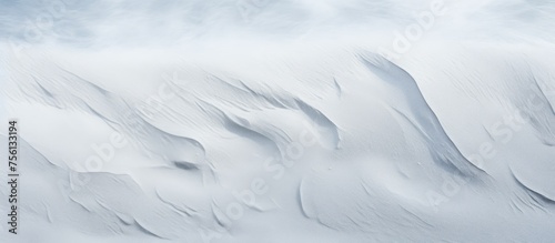 A closeup of a snowy slope with a blurred background, showcasing the freezing polar ice cap landscape beneath a cloudfilled sky