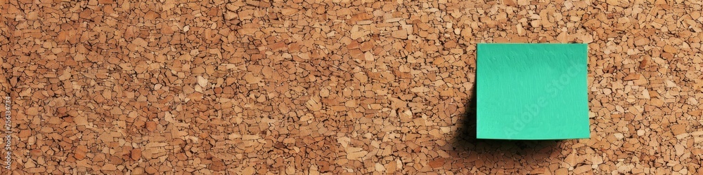 © Shutter2U - Simple yet essential a green memo on a cork surface symbolizing communication and the art of jotting down thoughts