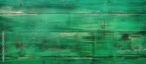 A close up of a symmetrical pattern of electric blue tints and shades on a rectangular green wooden wall, resembling terrestrial plant leaves