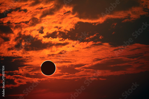 eclipse on the dark red sunset sky and transparent cloud