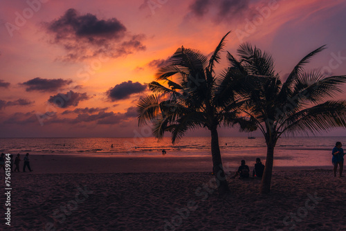 Tropical beach Sunset Palm trees on sandy island in the ocean