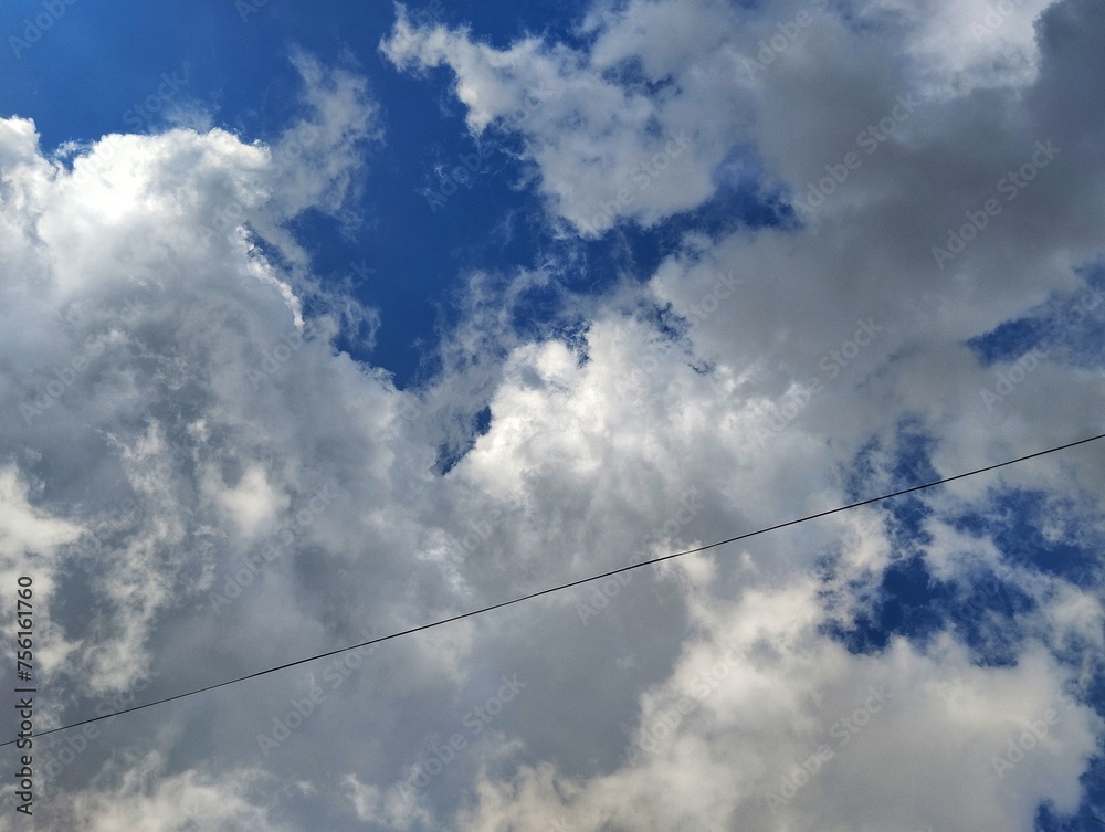 Electrical wire under white clouds Electrical wire under white clouds