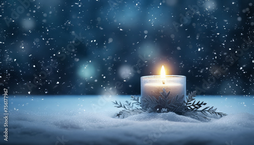 A candle is lit on a snowy ground