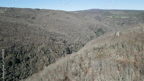 Aerial dolly above Navea River and road winding through Ourense Spain photo