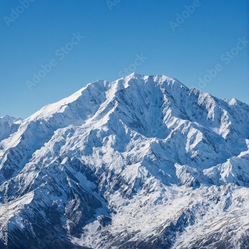 A snow-capped mountain range against a clear blue sky. © Shubham