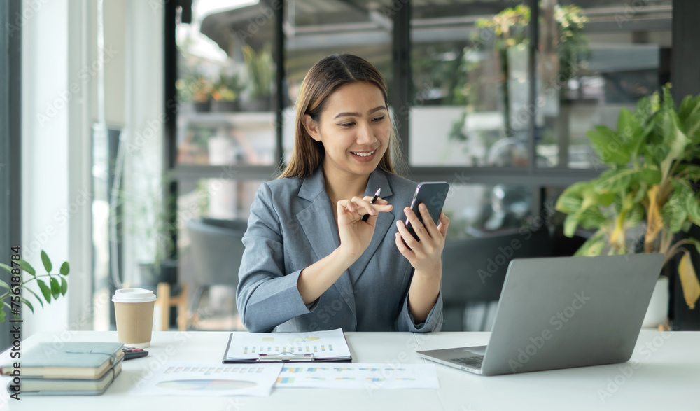 Asian businesswoman calculate financial graphs showing results about their investments, plan a successful business growth process Asian businesswoman calculate financial graphs showing results about their investments, plan a successful business growth process