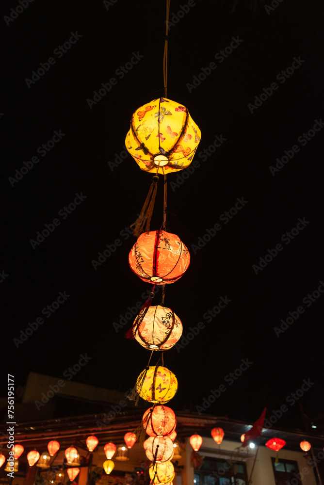 Brightly colourful lanterns hanging along a string Brightly colourful lanterns hanging along a string
