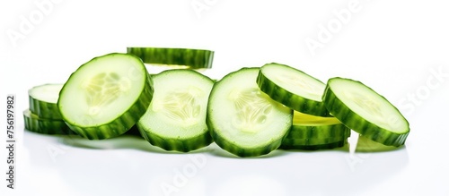 A pile of sliced cucumbers, a natural food and staple ingredient in many recipes, displayed on a white surface