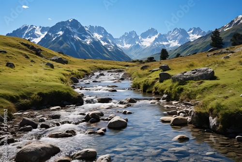 Scenic mountain river landscape with snow capped mountain peaks in the distance