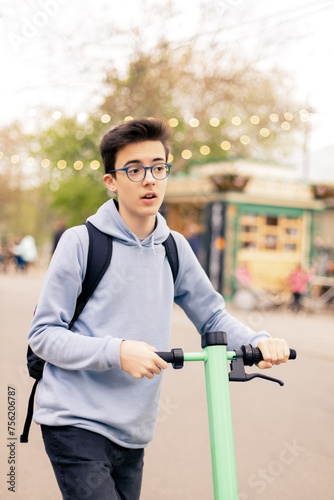 Teenager rides an electric scooter in the city