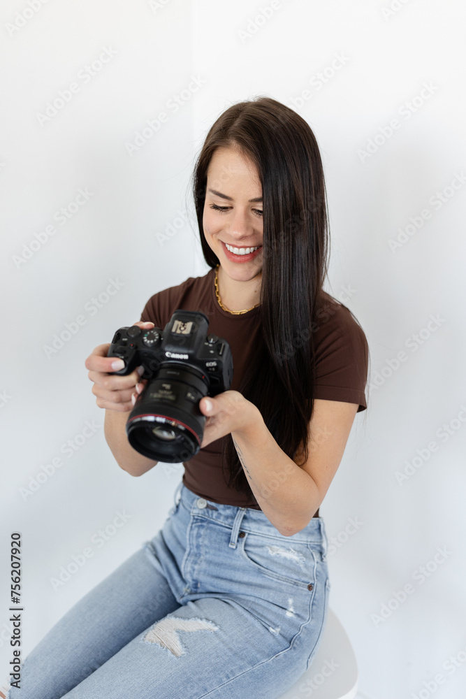 Happy woman reviewing shots on Canon camera Happy woman reviewing shots on Canon camera