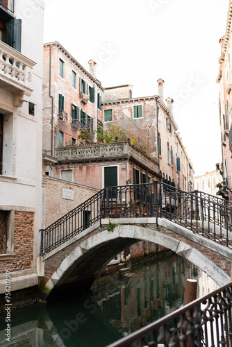 Quiet Venetian canal with arched bridge