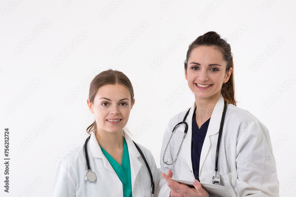 Two female healthcare workers wearing uniform and stethoscope. Two female healthcare workers wearing uniform and stethoscope.