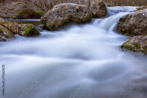 mountain stream flowing thorugh the rocks © taviphoto