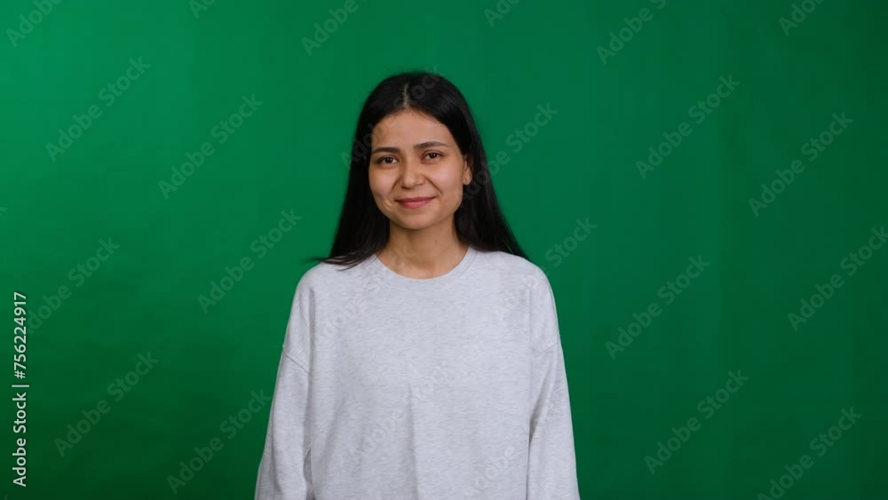 Young woman in a studio shot, expressing happiness, confidence, and positive emotion, creating a playful and joyful atmosphere. Young woman in a studio shot, expressing happiness, confidence, and positive emotion, creating a playful and joyful atmosphere.