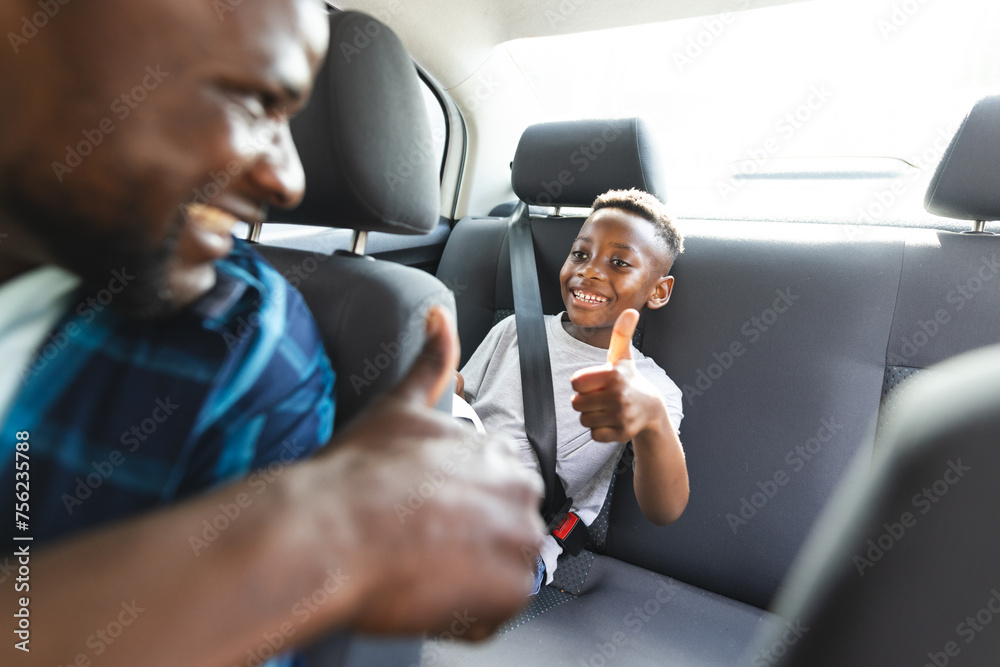 © Wavebreak Media - African American father and son share a joyful moment in a car, both giving thumbs up © Wavebreak Media - African American father and son share a joyful moment in a car, both giving thumbs up