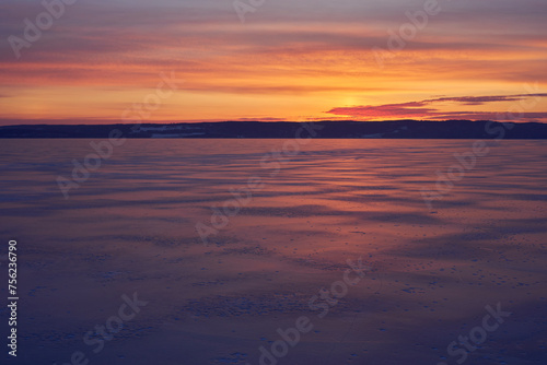 Sunrise above a frozen Lake Mjosa covered with ice  seen from Panengen in Totenvika a winter morning in March.