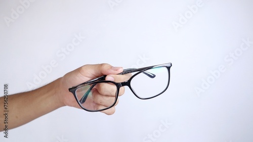 hand holding glasses, anti-radiation glasses, glasses for minus eyes, plus, cylinder