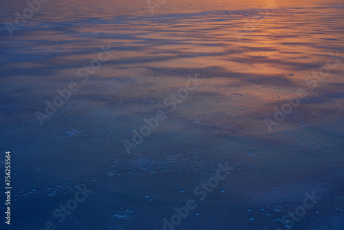 Sunrise above a frozen Lake Mjosa covered with ice, seen from Panengen in Totenvika a winter morning in March. photo