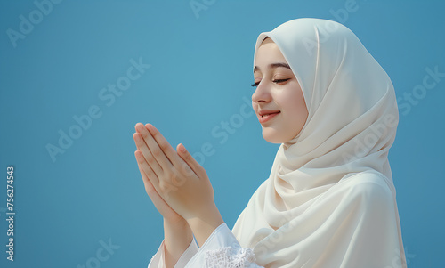 Asian woman in hijab is raising her hand while smiling on blue background, ramadan 2024 (ID: 756274543)